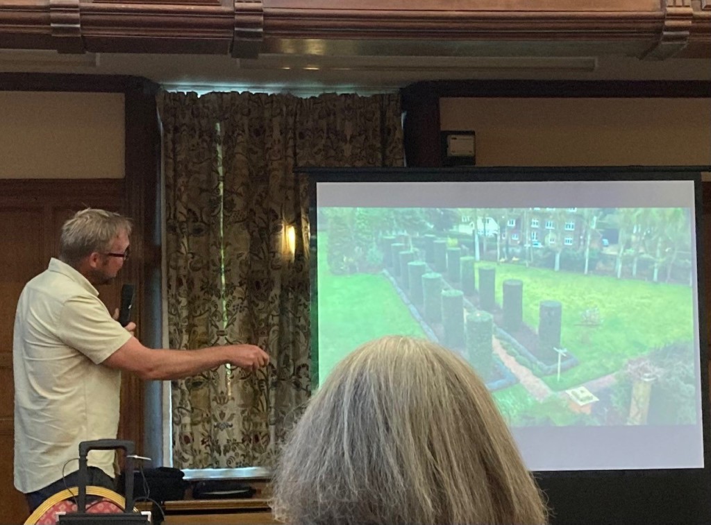 Steve Edney giving lecture, showing Holm oaks topiary